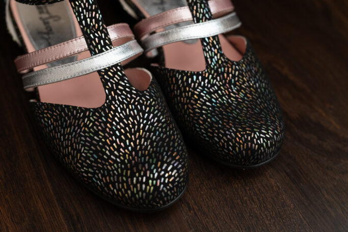 Black with colorful confetti freckles, pink and silver straps, leather sole, leather heel, leather upper