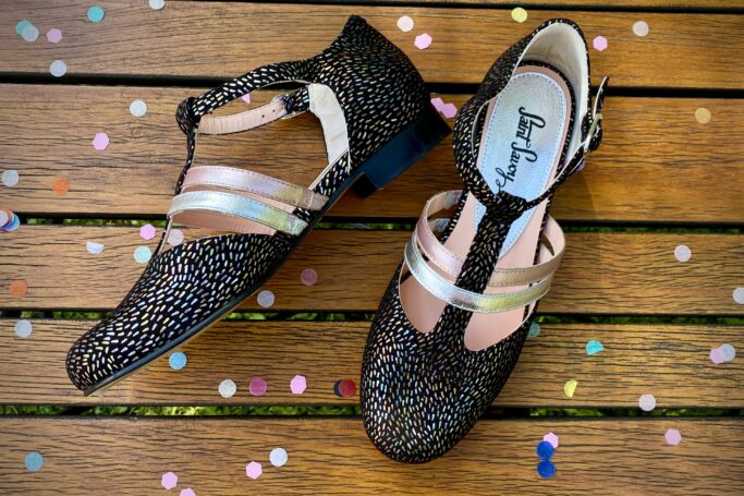 Black with colorful confetti freckles, pink and silver straps, leather sole, leather heel, leather upper